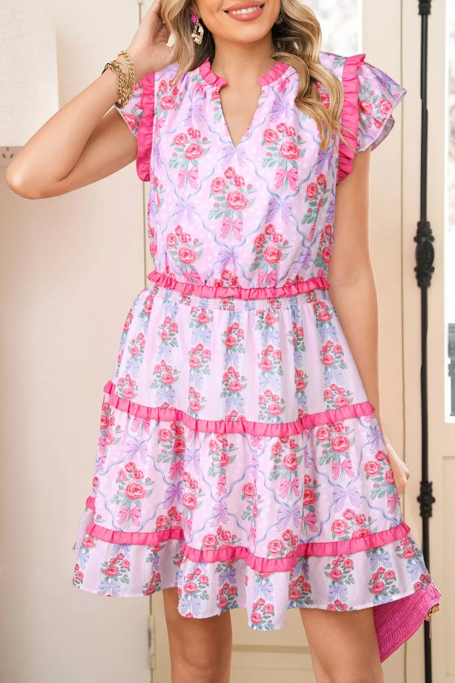 Floral tiered ruffle dress with elastic waist and pink trim, featuring a bouquet print on a light purple background.