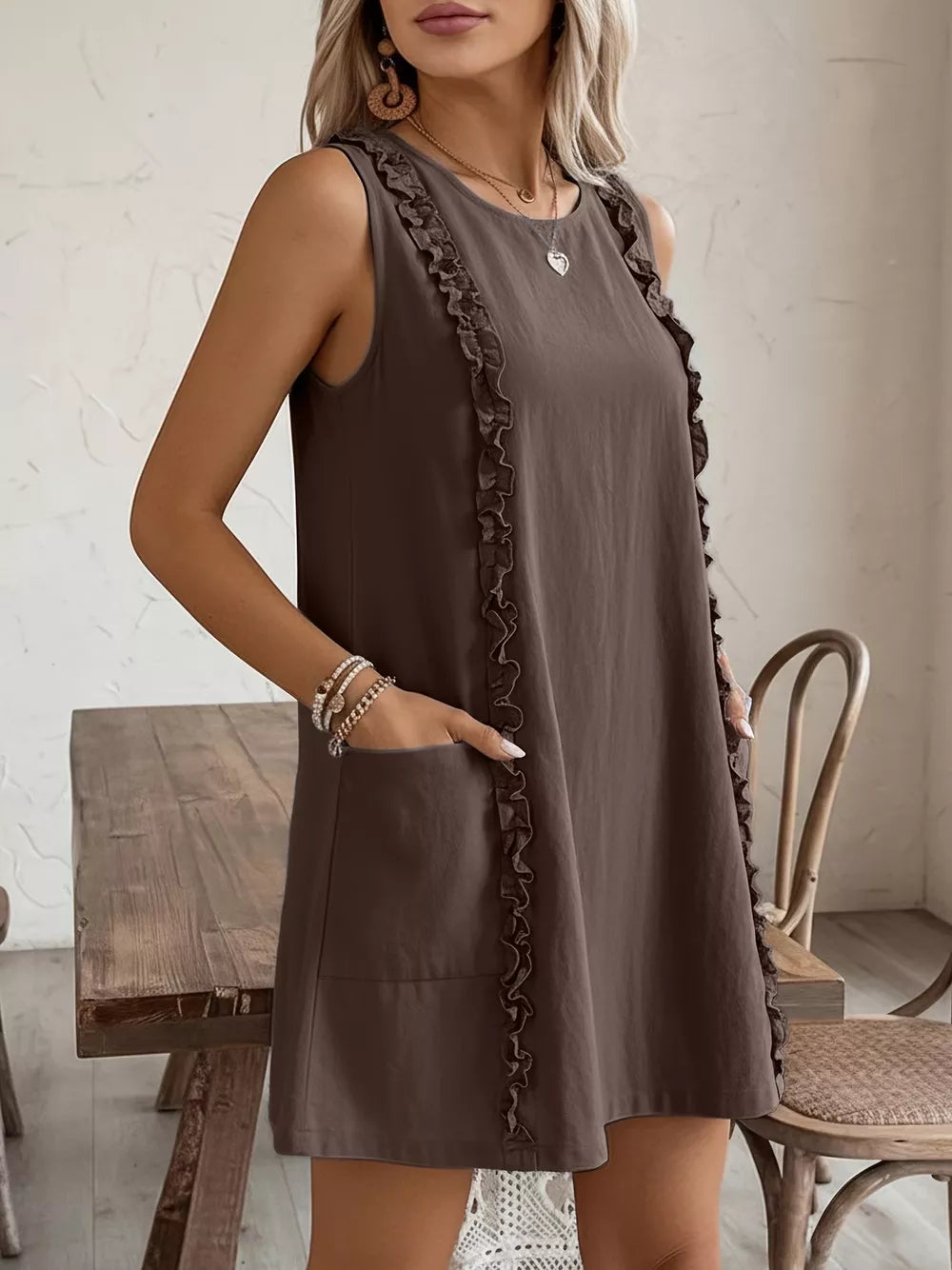 Coffee brown sleeveless dress with frill detail and pockets.
