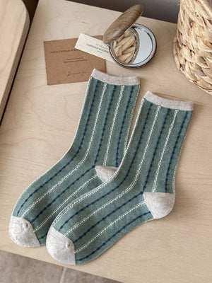 navy blue socks featuring mid-calf length and striped