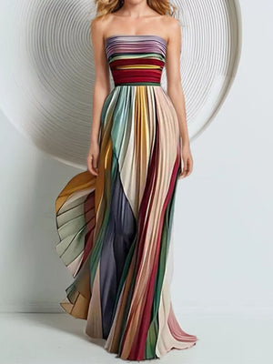 Vibrant striped strapless maxi dress with flowing pleated skirt.
