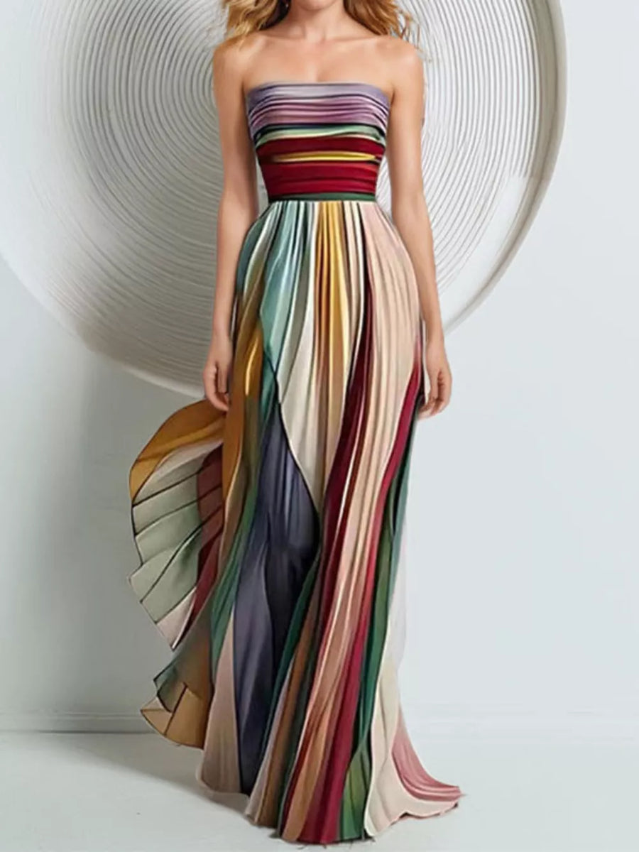 Vibrant striped strapless maxi dress with flowing pleated skirt.