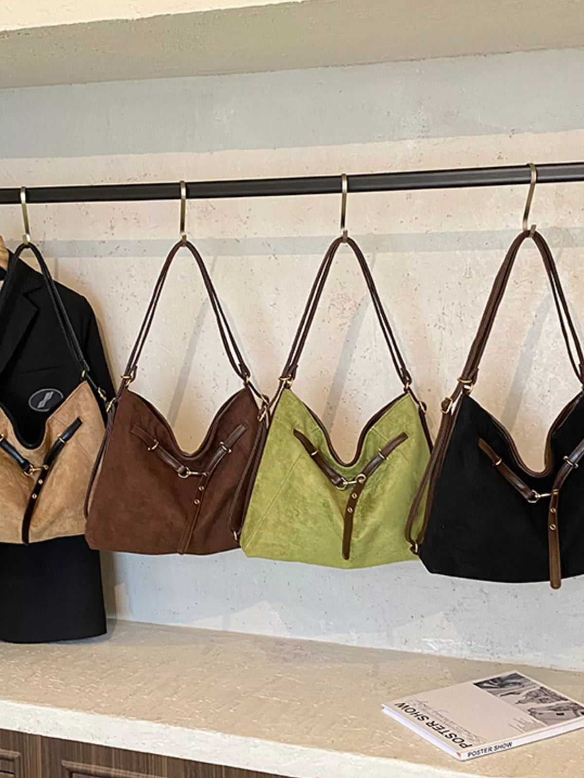 Chic suede tote shopper bags in black, green, brown, and khaki with leather trim and strap details.