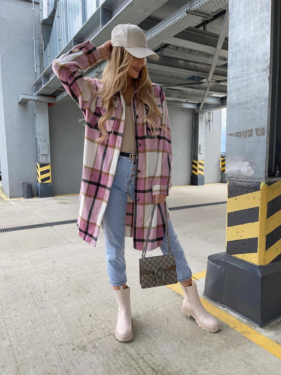 Long plaid shirt jacket in pink and white with a collar and button front, styled with jeans.