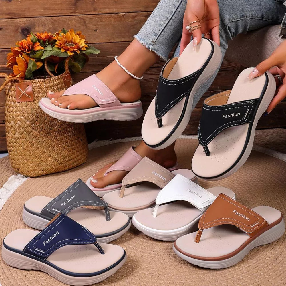 Platform toe post sandals in pink, black, gray, blue, white, and tan with contrast stitching.