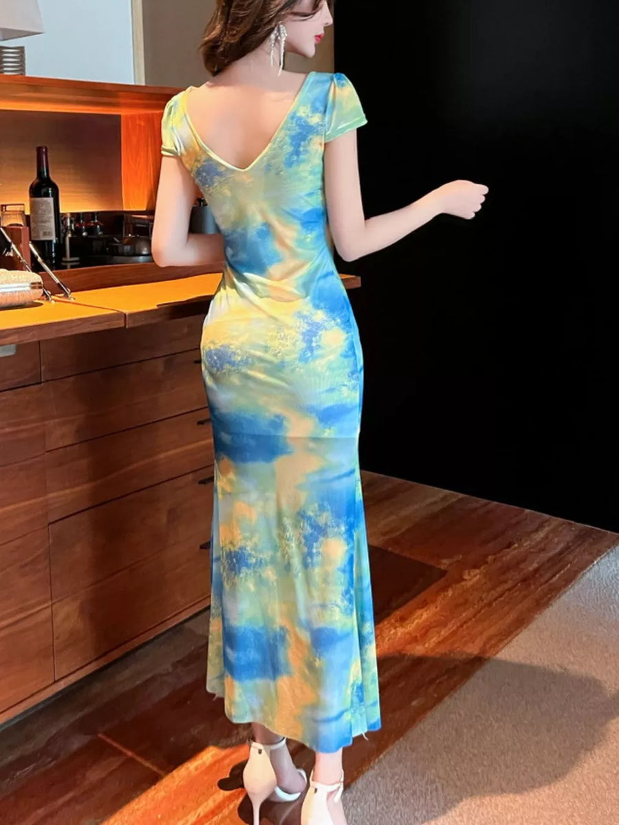 Surplice ruffle maxi dress in blue and yellow tie-dye with short sleeves.