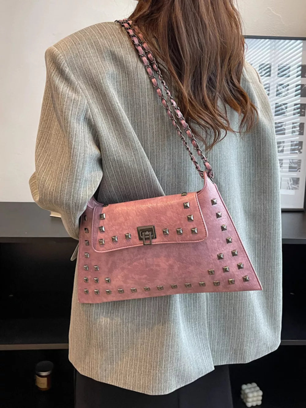 Pink embellished chain flap shoulder bag with studded detail and metal clasp.
