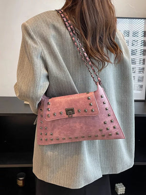 Pink embellished chain flap shoulder bag with studded detail and metal clasp.
