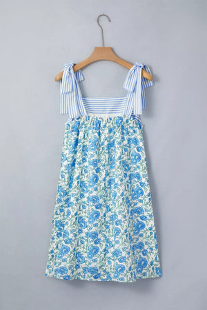 Botanical print mini dress with tie straps and blue stripes on bodice.