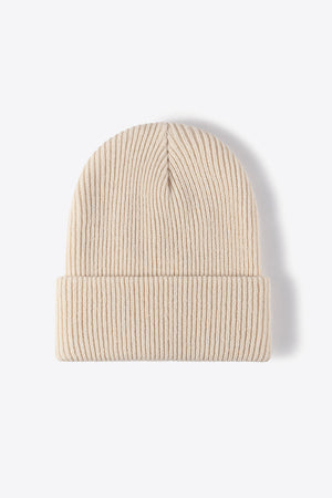 Beige ribbed knit beanie with a cuffed brim, made of acrylic.