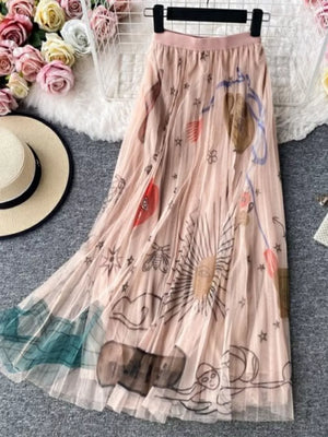 Pink tulle midi skirt with abstract sunburst print and green hem detail.