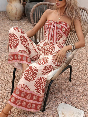 Floral tie-front wide-leg romper in cream with rust print, strapless neckline, and wide legs.