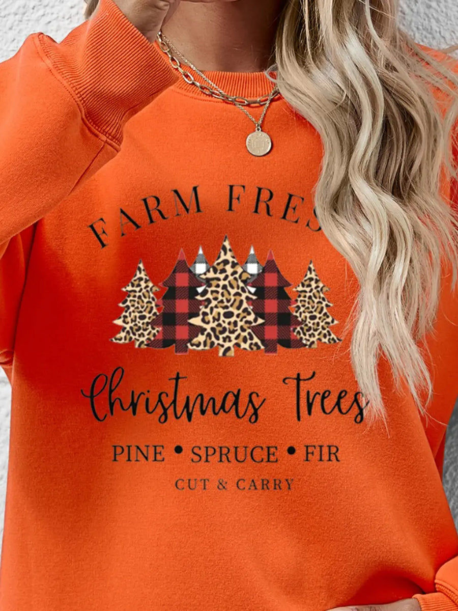 Orange crewneck sweatshirt with Christmas trees graphic and text.