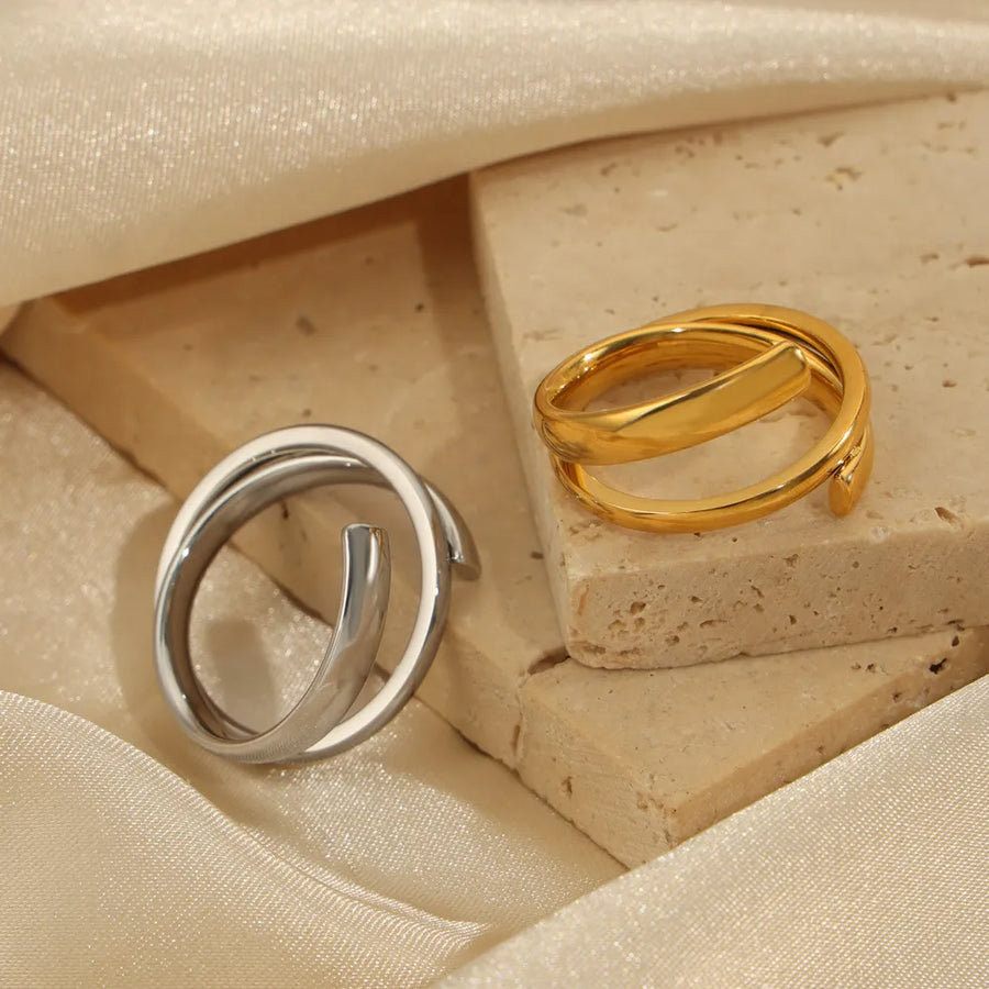Sculptural spiral steel rings in gold and silver, modern minimalist jewelry for women.