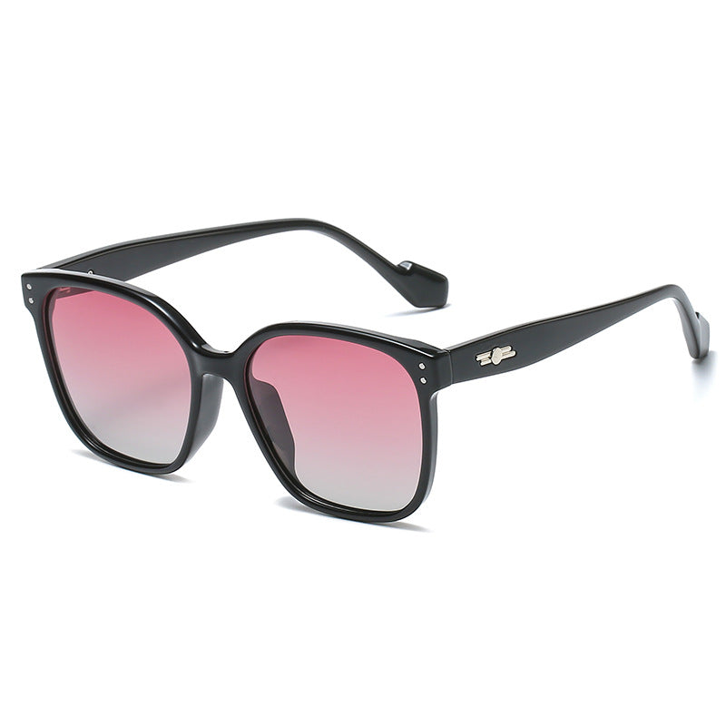Chic oversized sunglasses with black frames and gradient pink lenses.