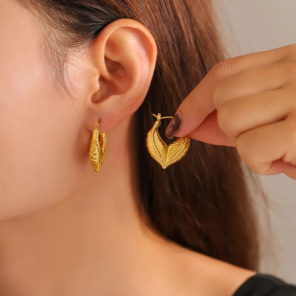 Textured gold leaf hoop earrings with 18K gold plating.