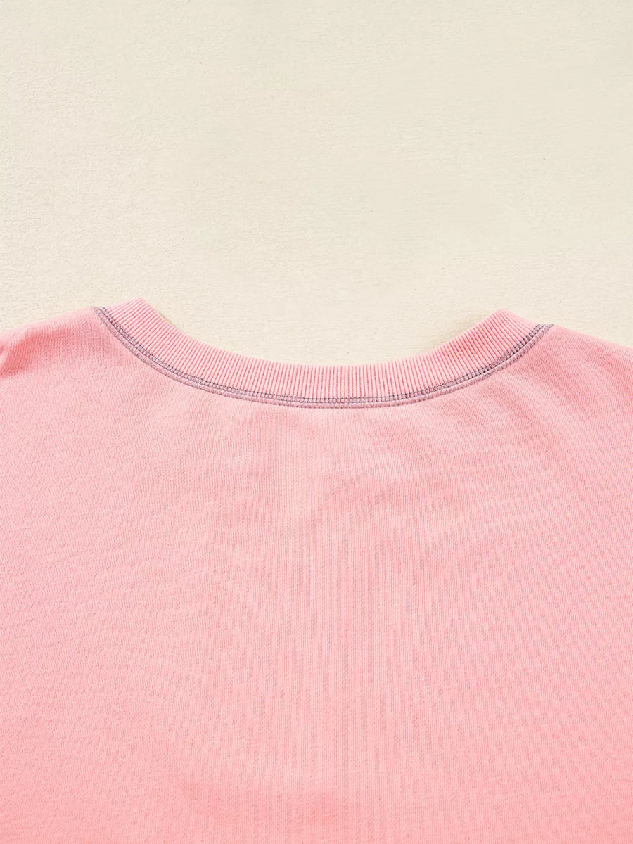 Dusty pink oversized sweatshirt with contrast stitching detail at the neckline.