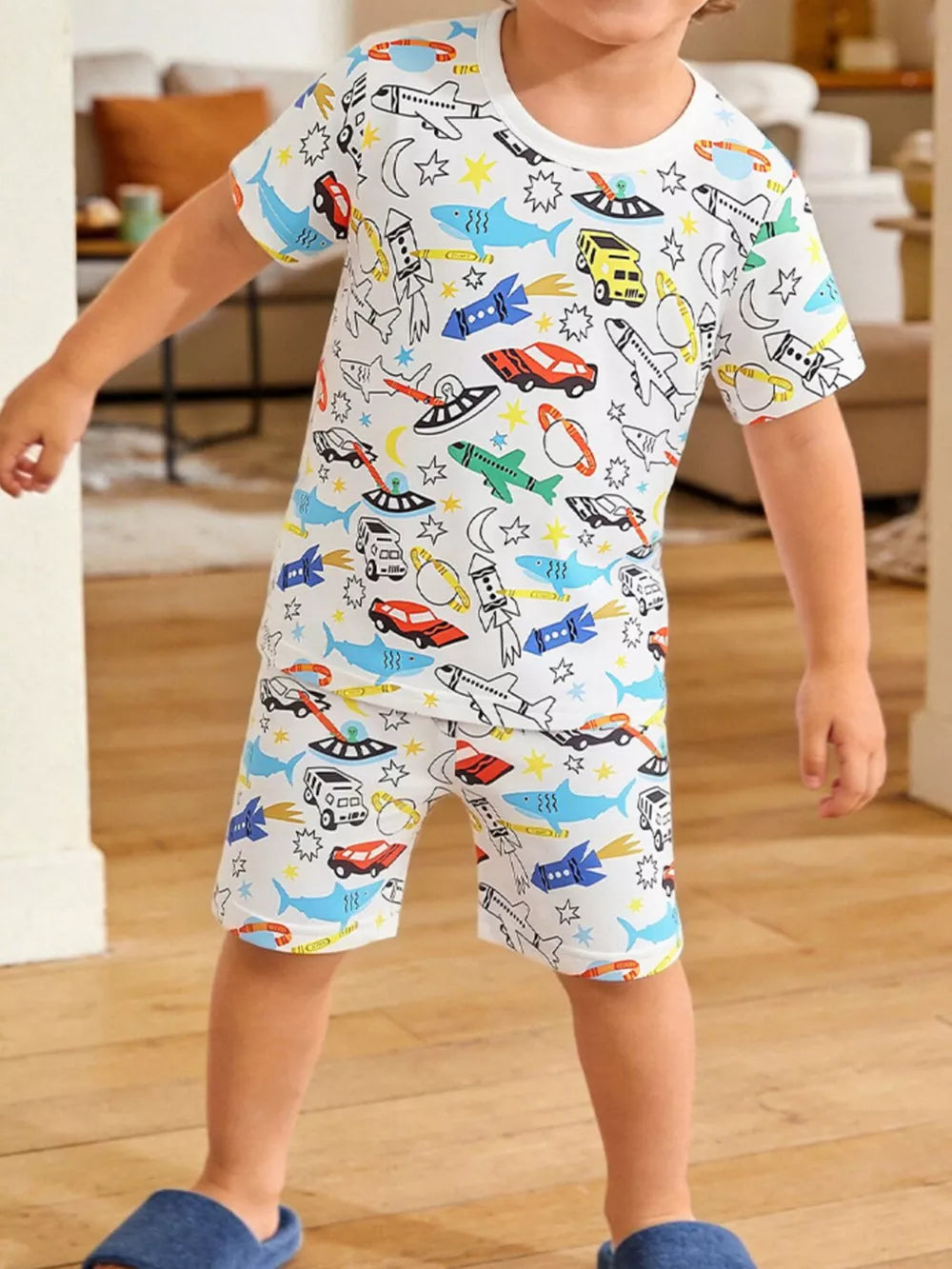 Toddler white short sleeve t-shirt and shorts set with a whimsical vehicle and space print.