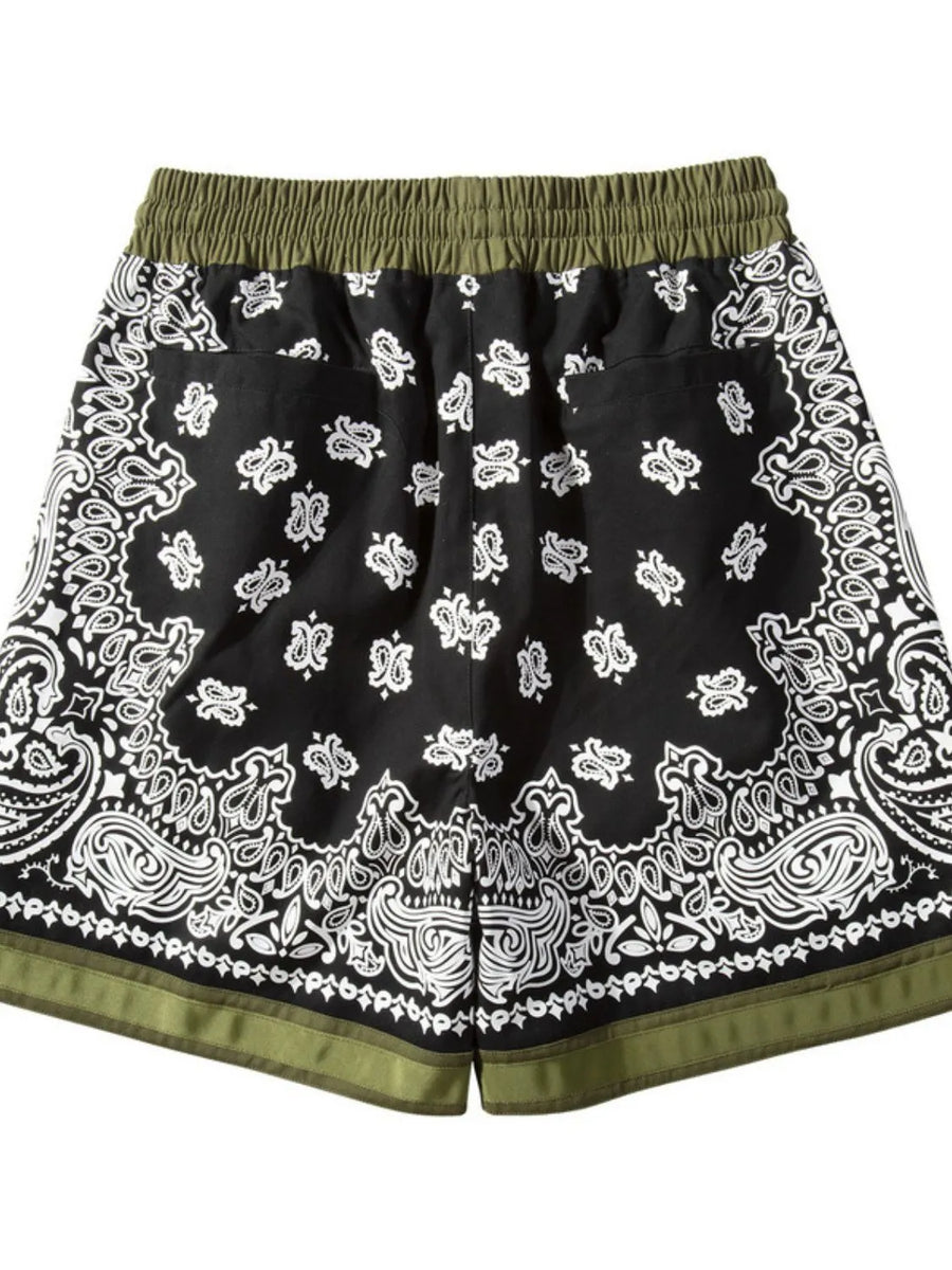 Black bandana print sport shorts with green waistband and metallic trim detail.