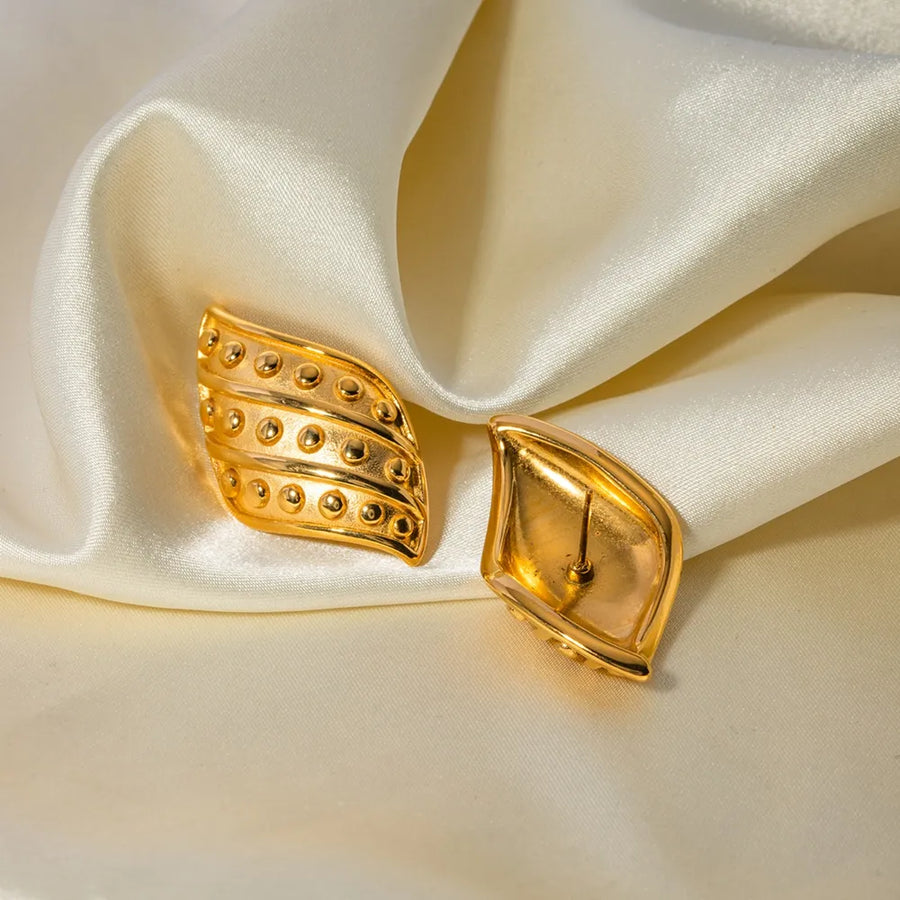 Sculpted gold leaf stud earrings with raised dot detail, 18K gold-plated.