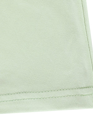 Light green ruffled mermaid maxi dress detail showing hem stitching