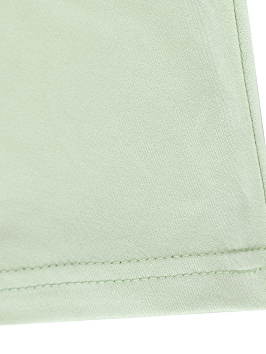 Light green ruffled mermaid maxi dress detail showing hem stitching