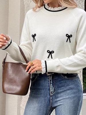 black pullover sweater featuring bow and bow motif