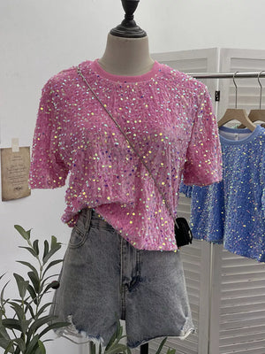 Pink crew neck t-shirt with iridescent sequin embellishments and short sleeves.