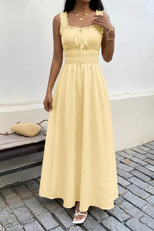 Yellow smocked floral maxi dress with frill straps and tie neckline.