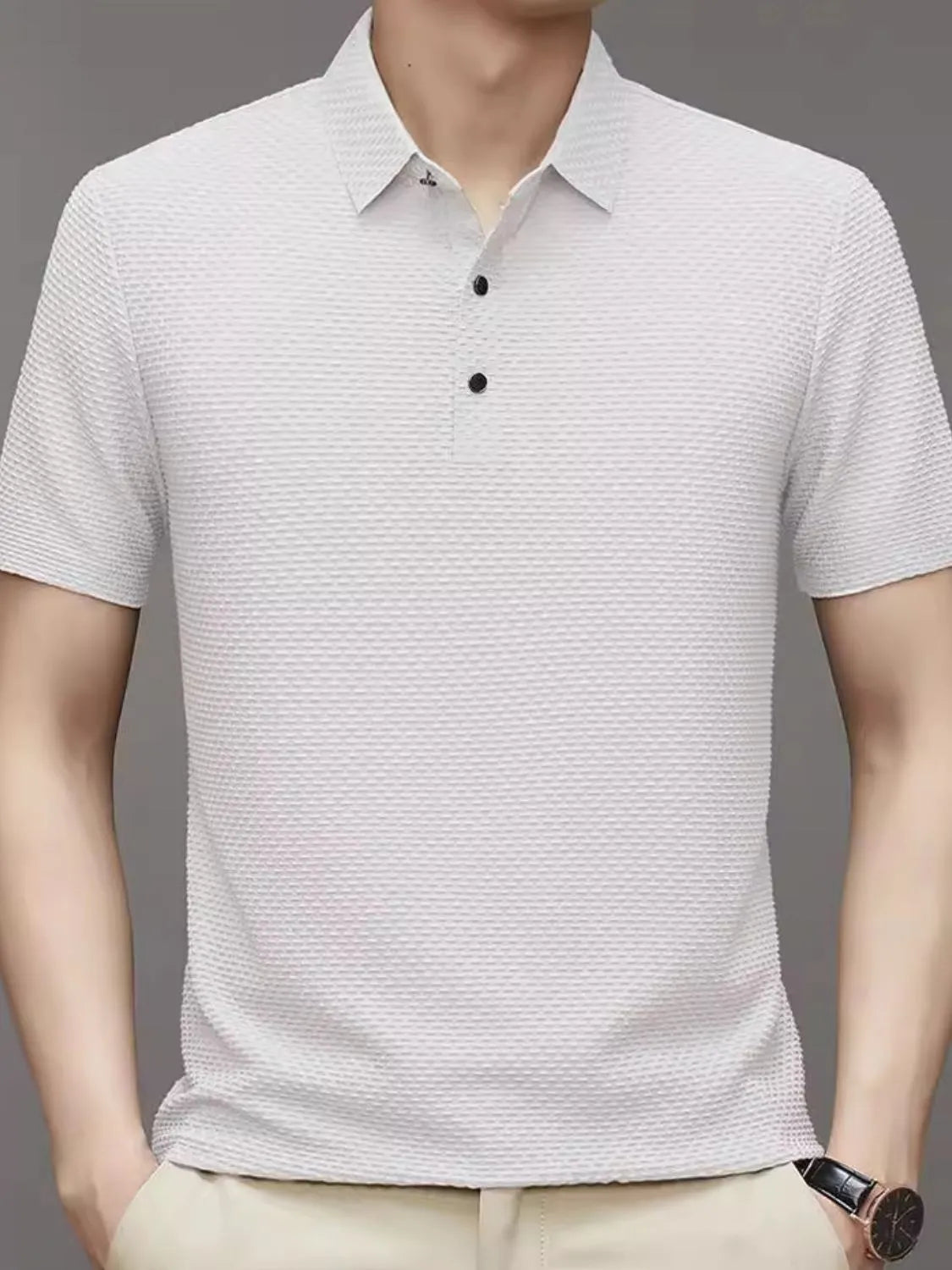White textured knit polo shirt with a classic collar and two-button placket.