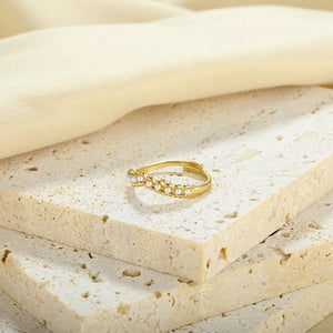 Gold adjustable ring with delicate pearl embellishments.