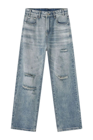 Baggy ripped denim jeans in medium wash with distressed details.
