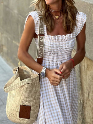Beige gingham maxi dress with smocked bodice and ruffled cap sleeves.