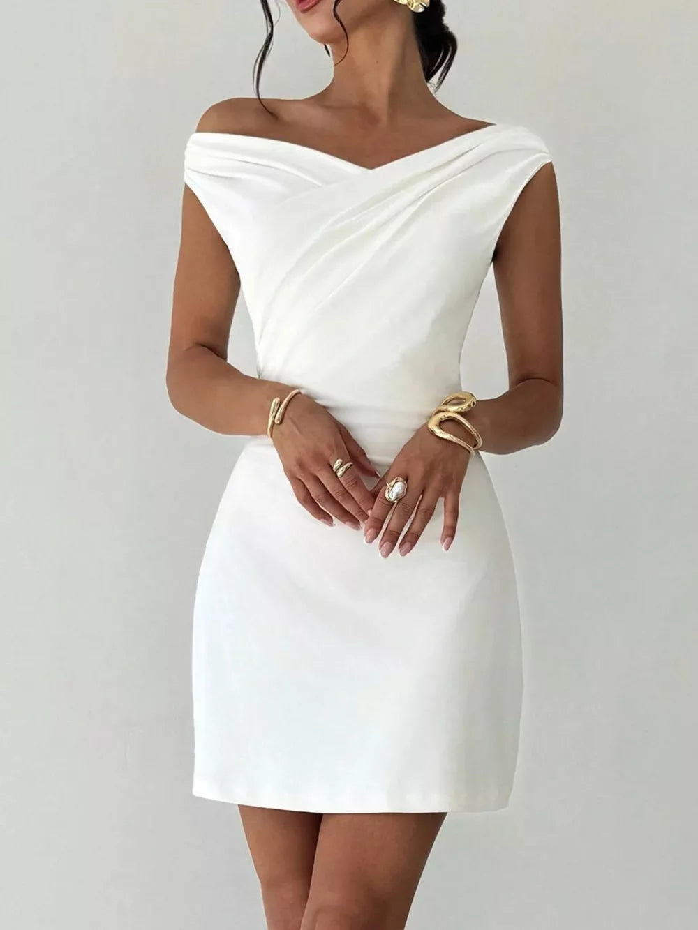 White draped sweetheart off-shoulder mini dress with a casual, above-the-knee cut.