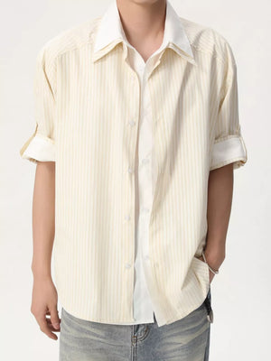 Men's yellow striped button-up shirt with rolled sleeves and white collar.