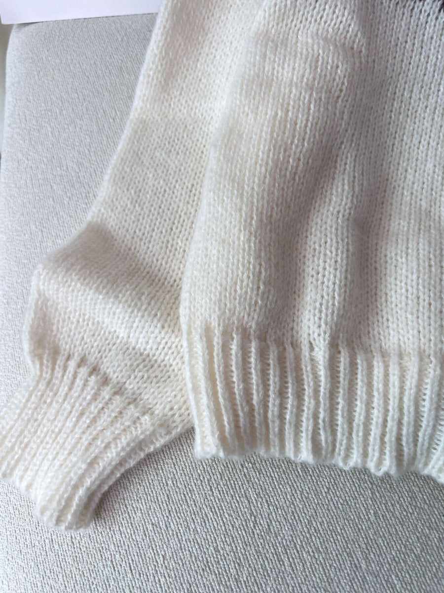 dark brown pullover sweater with ribbed cuffs and long sleeve