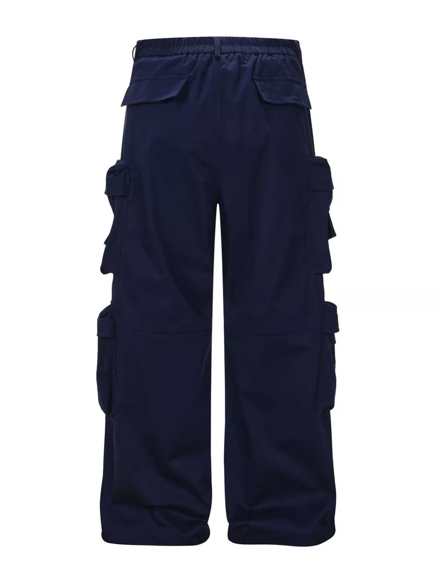 Navy blue cargo pants with multiple flap pockets and a relaxed fit.