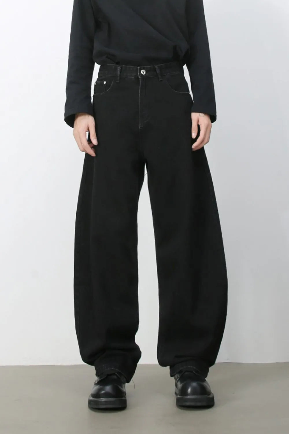 Black denim balloon trousers with a wide leg and high waist.
