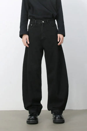 Black denim balloon trousers with a wide leg and high waist.