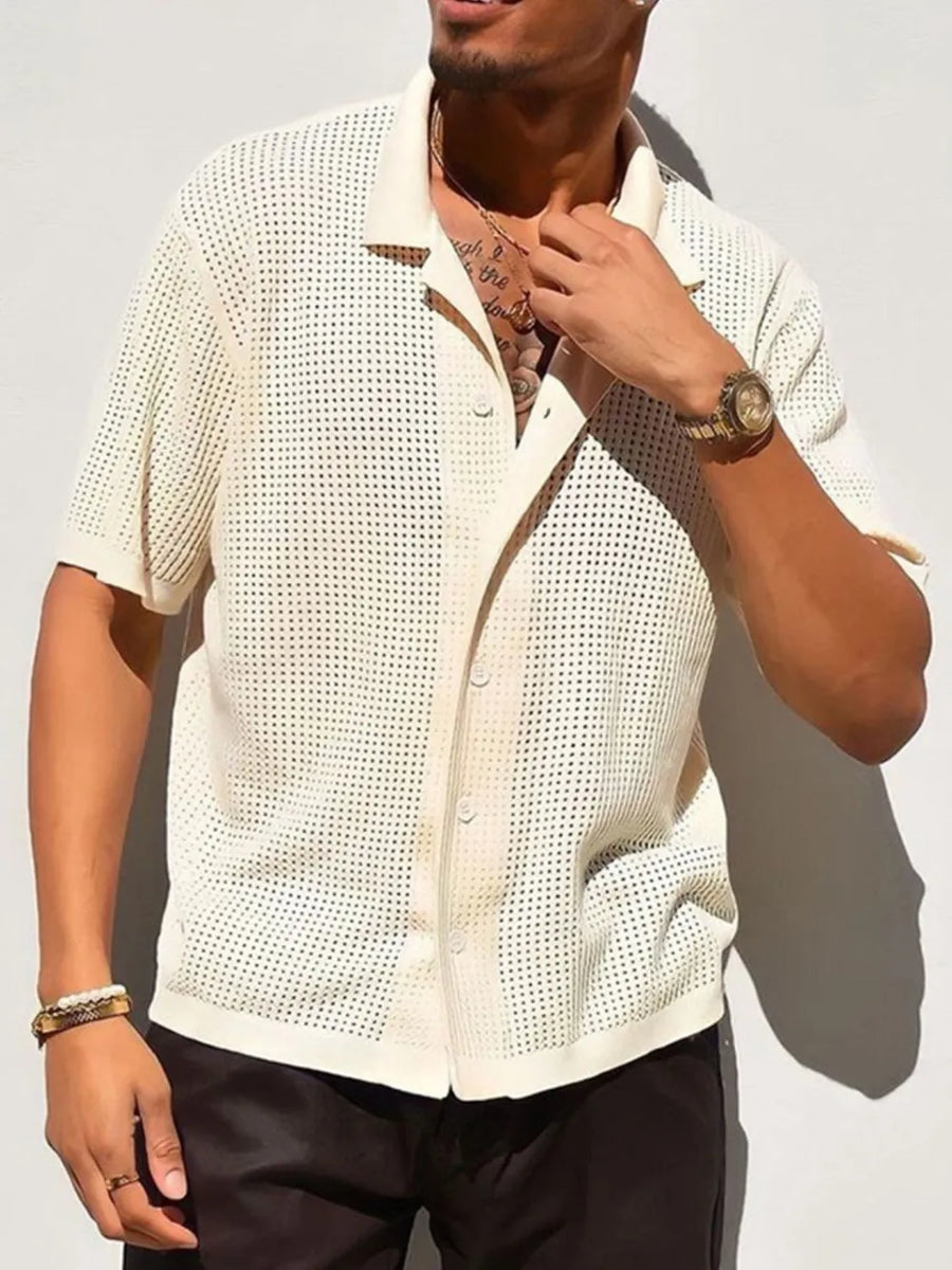 Ivory perforated knit resort shirt with short sleeves and a button-up collar.