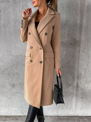 Chic double-breasted longline trench coat in apricot with button details.
