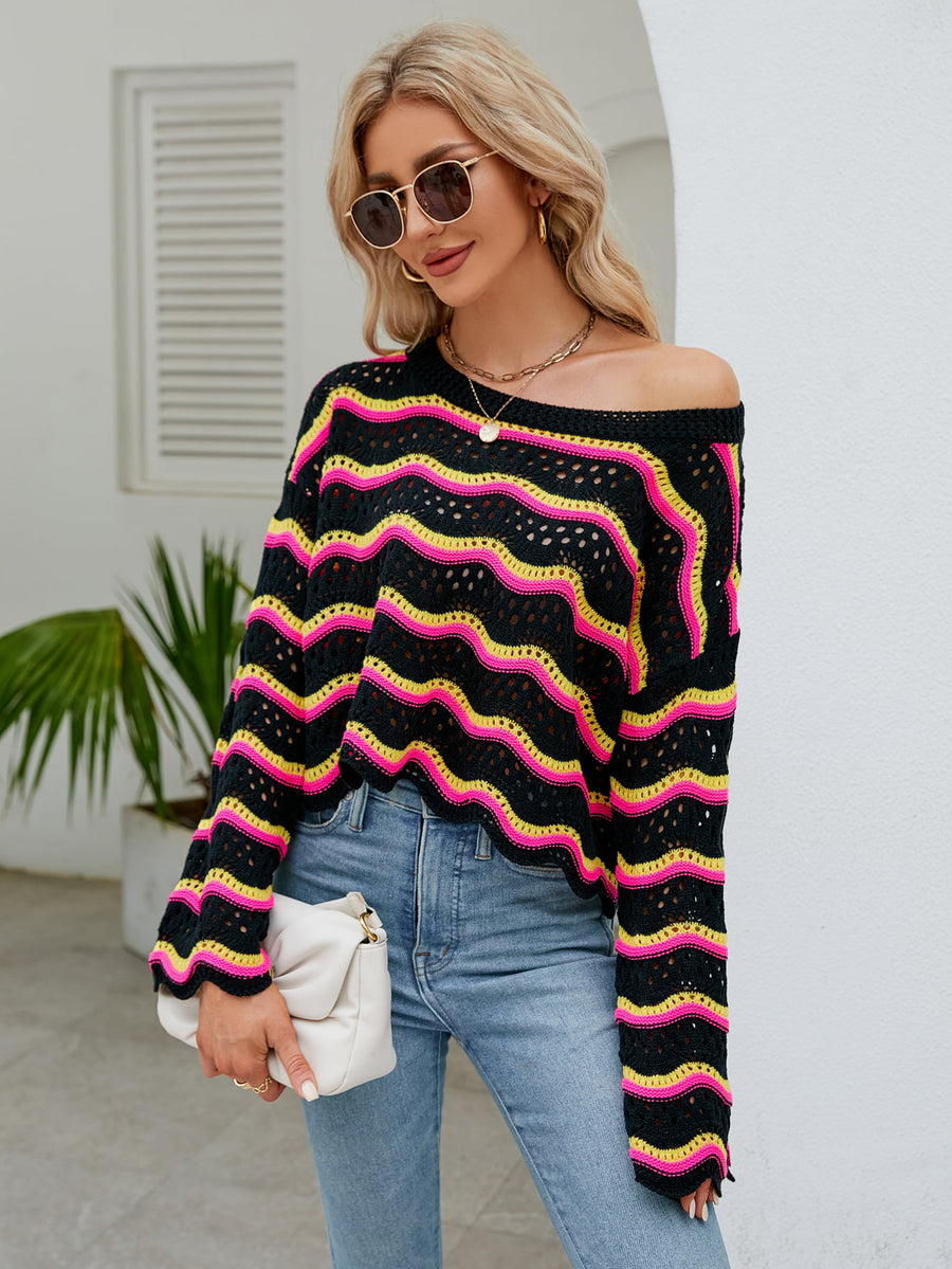 Black crochet crop sweater with pink and yellow zigzag stripes, off-the-shoulder neckline.