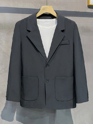 Dark grey single-breasted blazer with notch lapels, two buttons, and patch pockets.