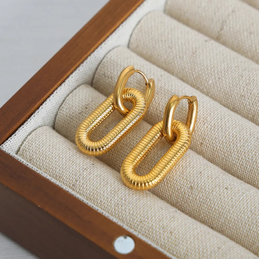 Textured oval link drop earrings in gold with ribbed detail.