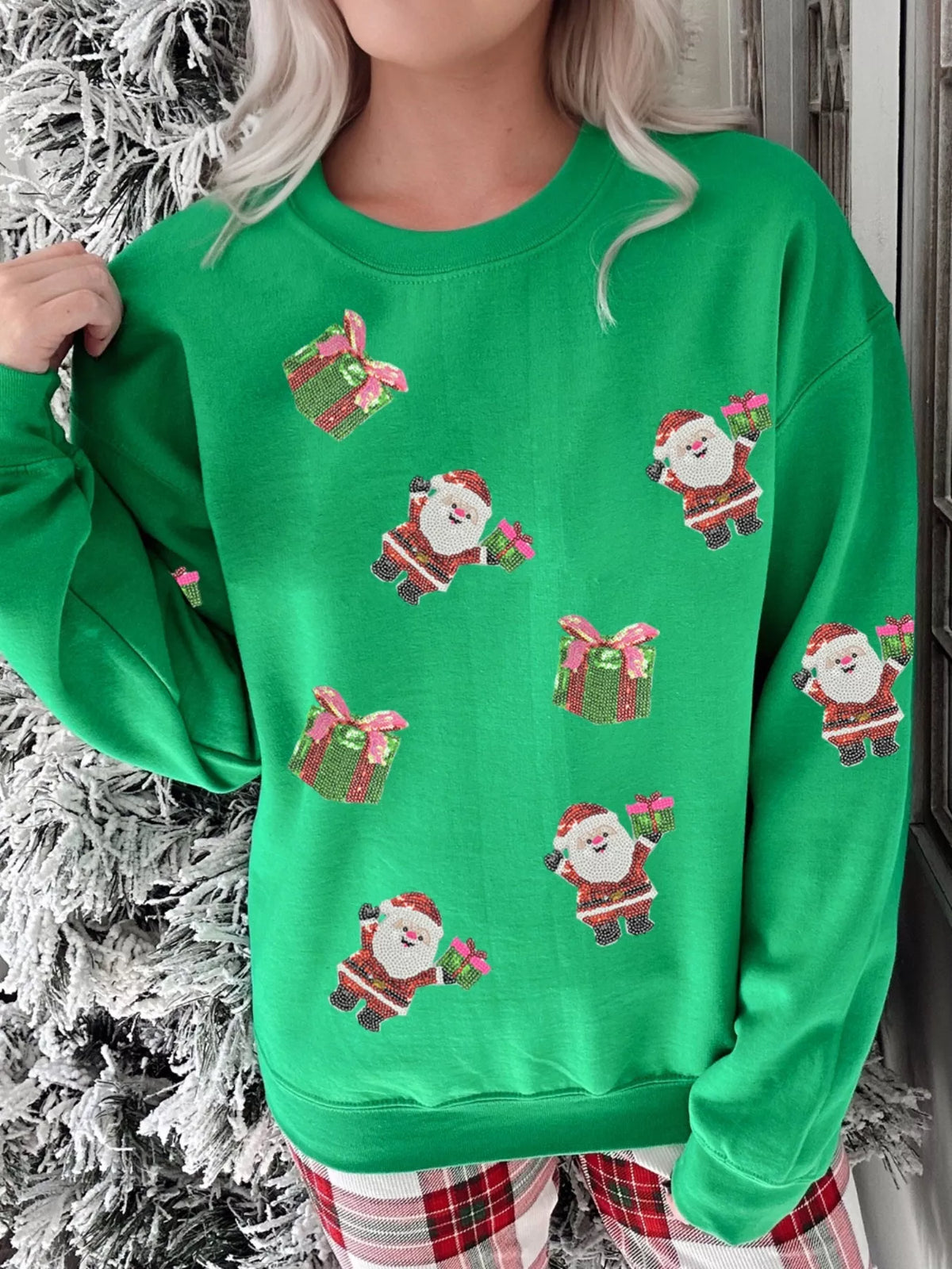 Green crewneck sweatshirt with allover sequin Santa and gift print.