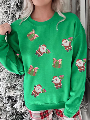 Green crewneck sweatshirt with allover sequin Santa and gift print.