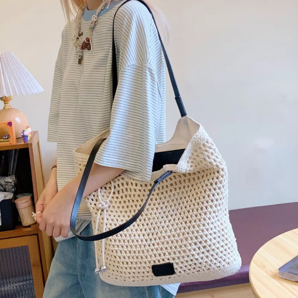 Black tote featuring crochet knit and geometric