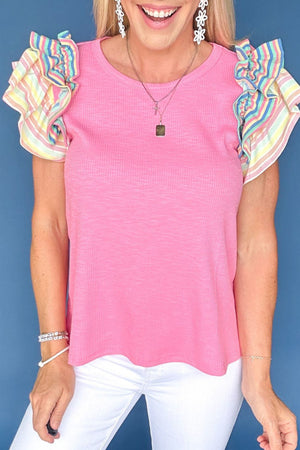 Pink ribbed knit top with pastel stripe ruffle sleeves.