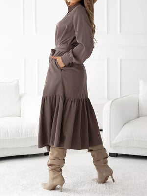 Coffee brown midi dress with ruffle hem, tie waist, and ruffled cuffs.