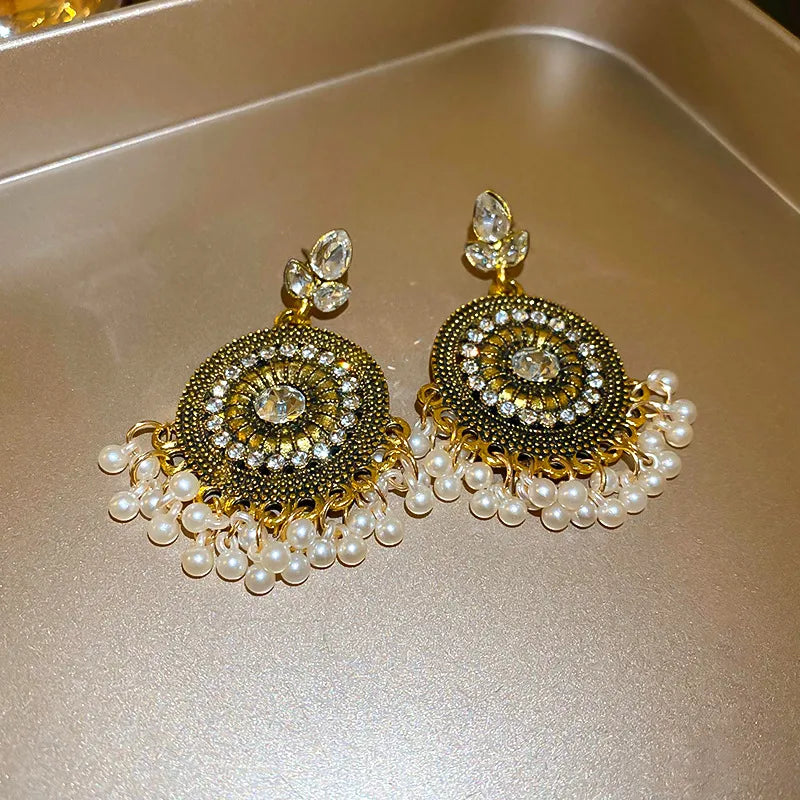 Beaded medallion and pearl drop earrings with crystal accents.