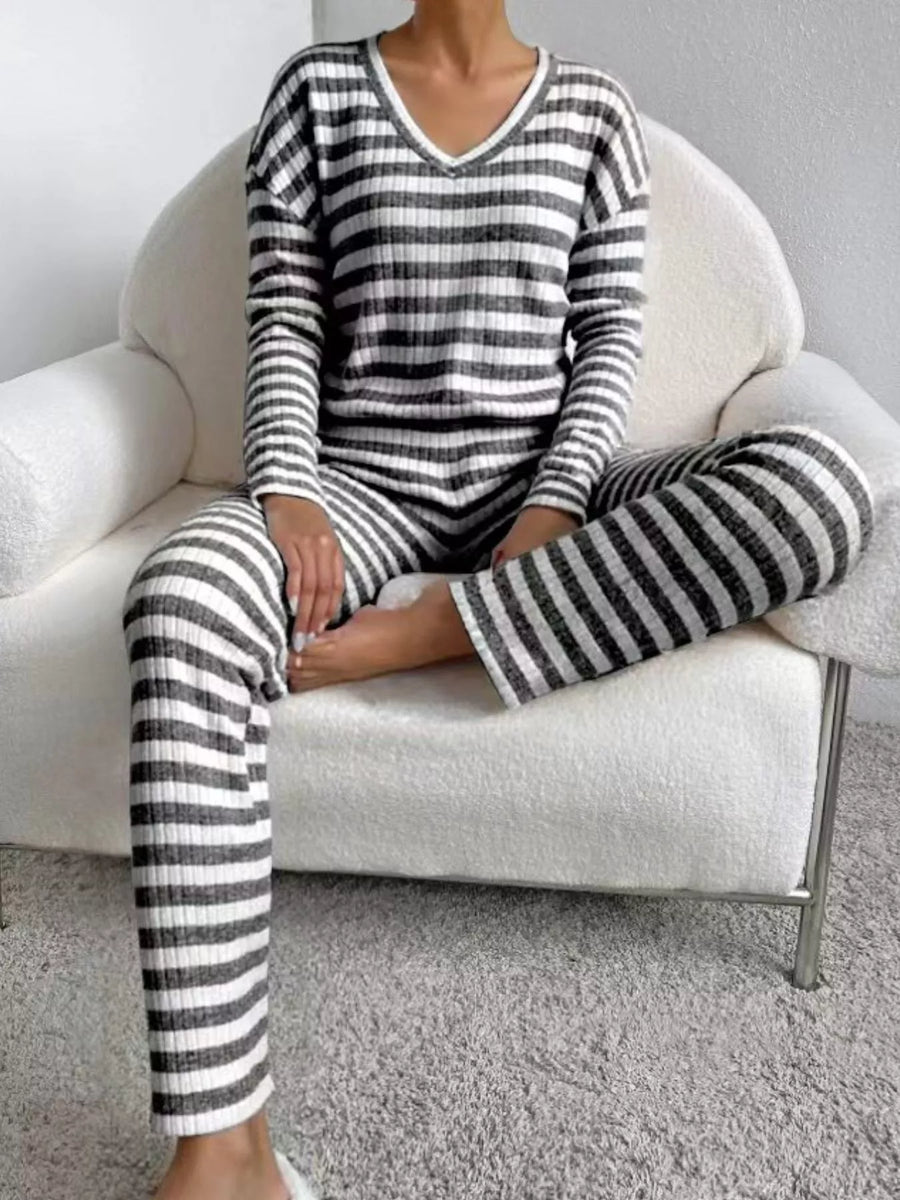 Black striped knit loungewear set with V-neck top and long sleeves.